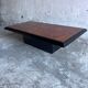 Vintage coffee table in wood burl on a black lacquered base.