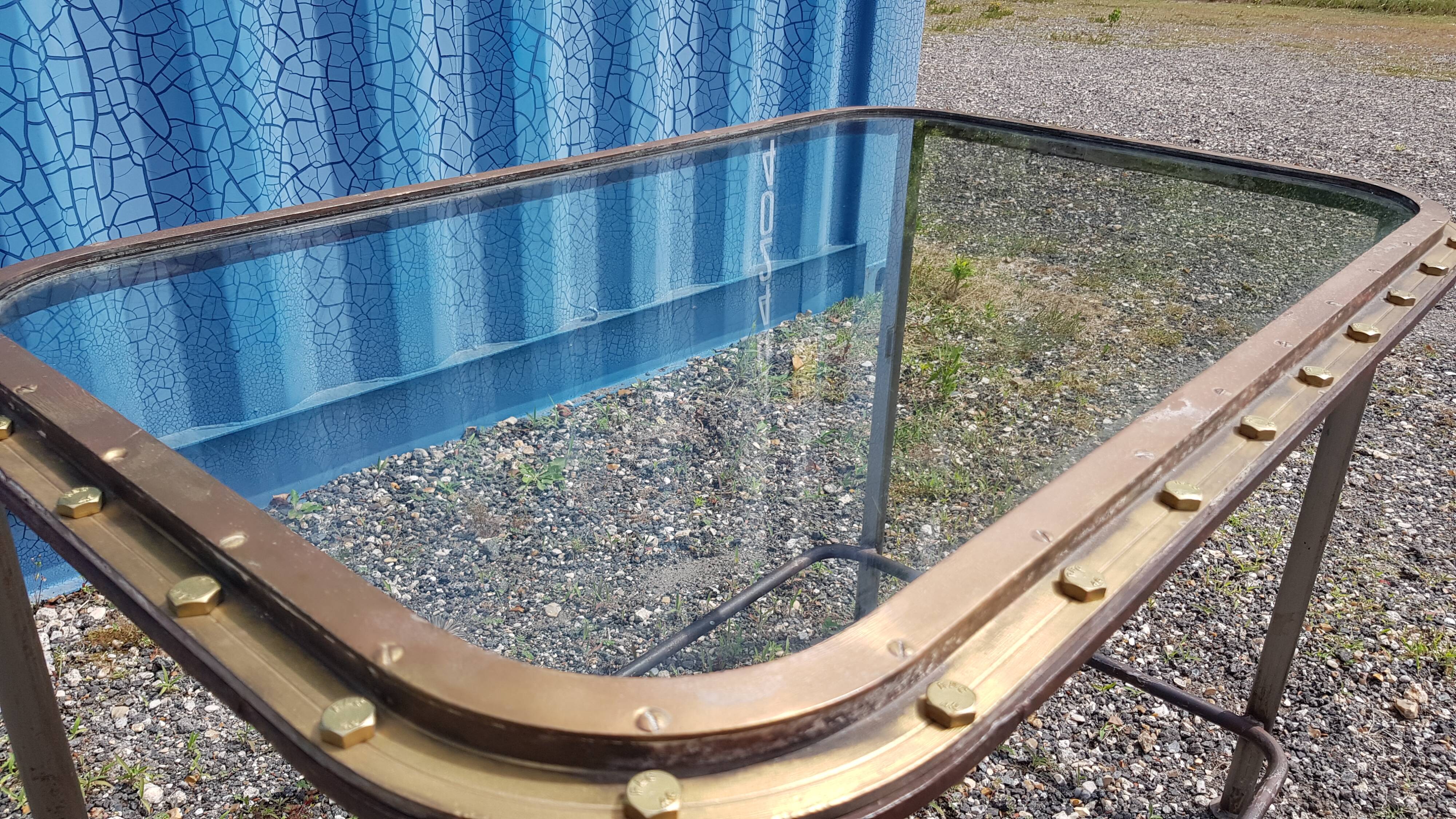 Table with an old ship porthole in brass and a metal base / 110 x 70 x 76 cm