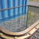 Table with an old ship porthole in brass and a metal base / 110 x 70 x 76 cm