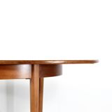 A stylish vintage teak danish influenced extending dining table for sale.  Supported on four slender