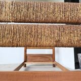 Brutalist style bed with chain and straw