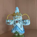 Antique earthenware salt cellar with a woman with baskets