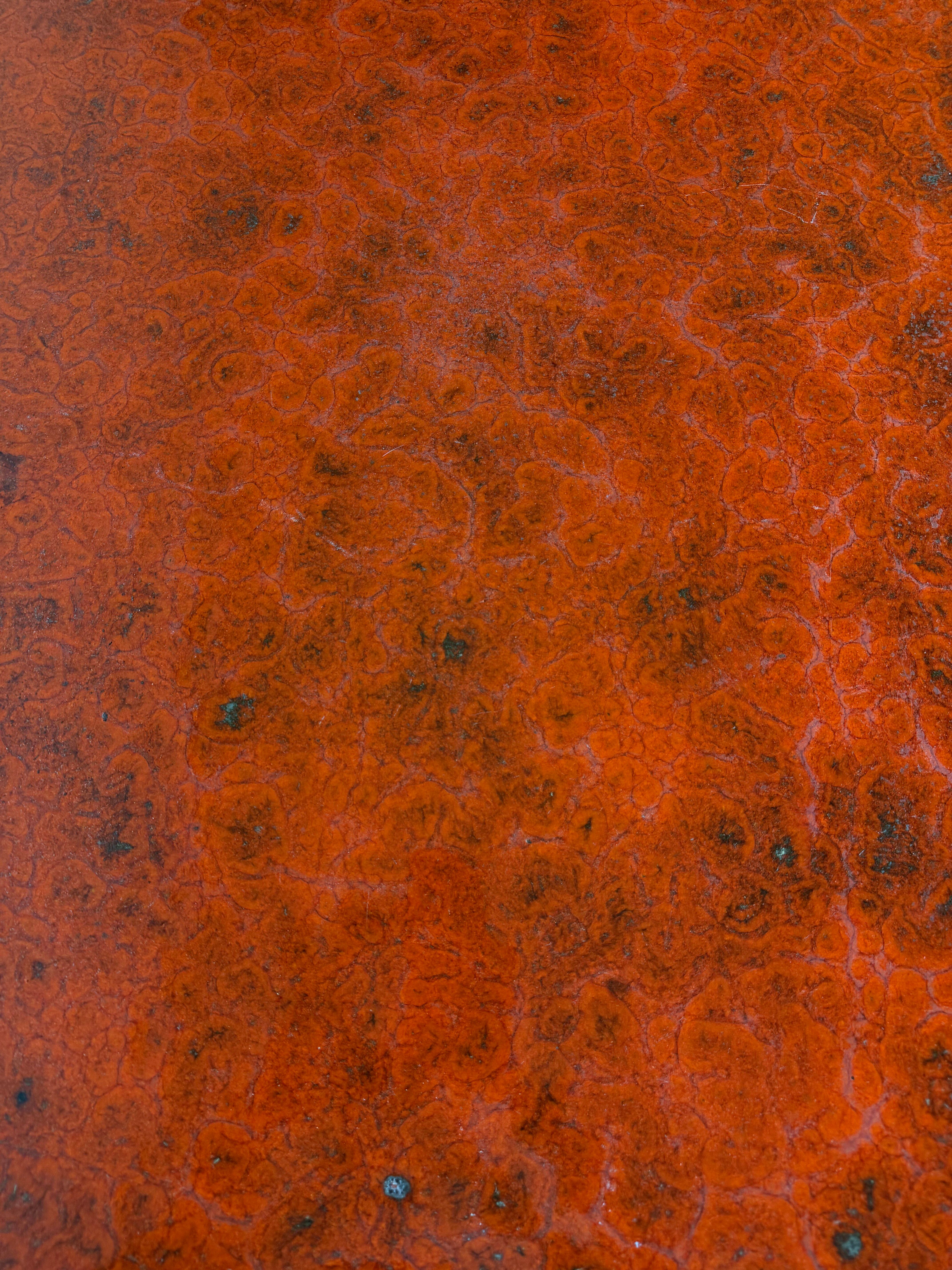 Vintage bistro table with orange-red ceramic.
