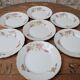 7 dessert plates in porcelain with a violet lilac design and a gold rim.
