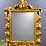 Antique Louis XV style mirror in gilded carved wood.
