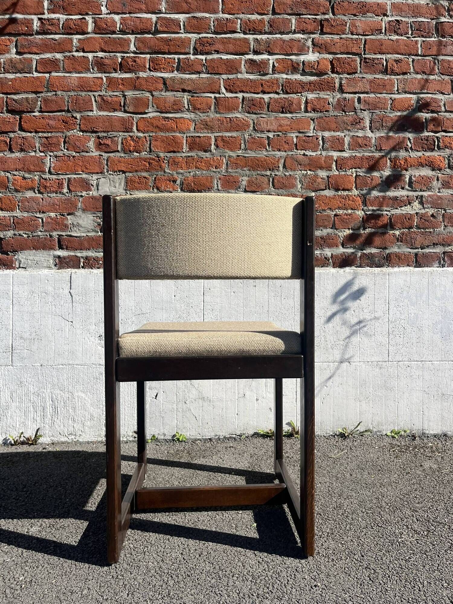 Many mid-century vintage wooden and fabric chairs.