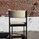 Many mid-century vintage wooden and fabric chairs.
