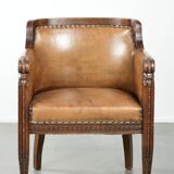 Antique armchair made of sheepskin and wood with decorative nails