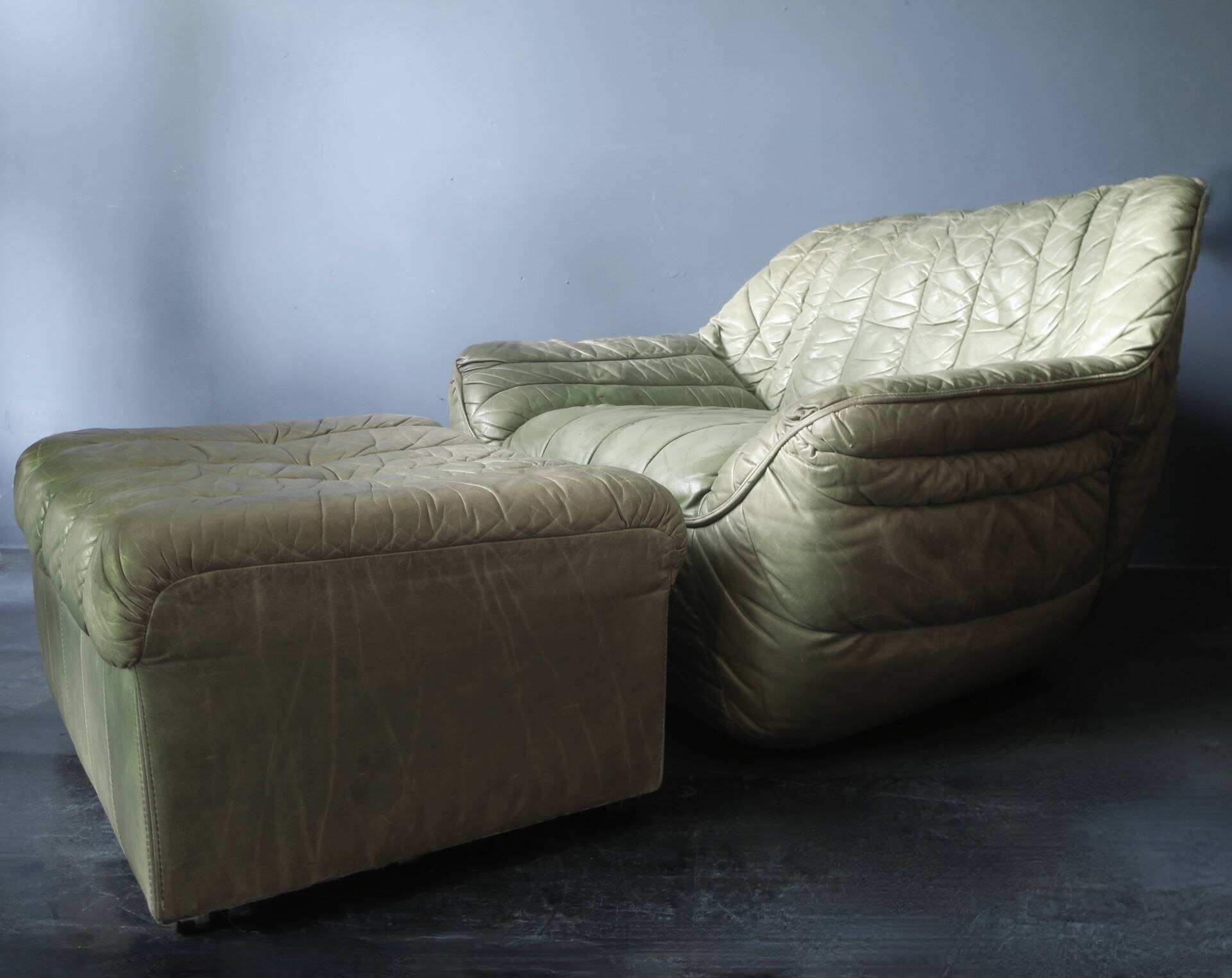 Laauser lounge chair and ottoman in olive green patchwork leather, 1970s