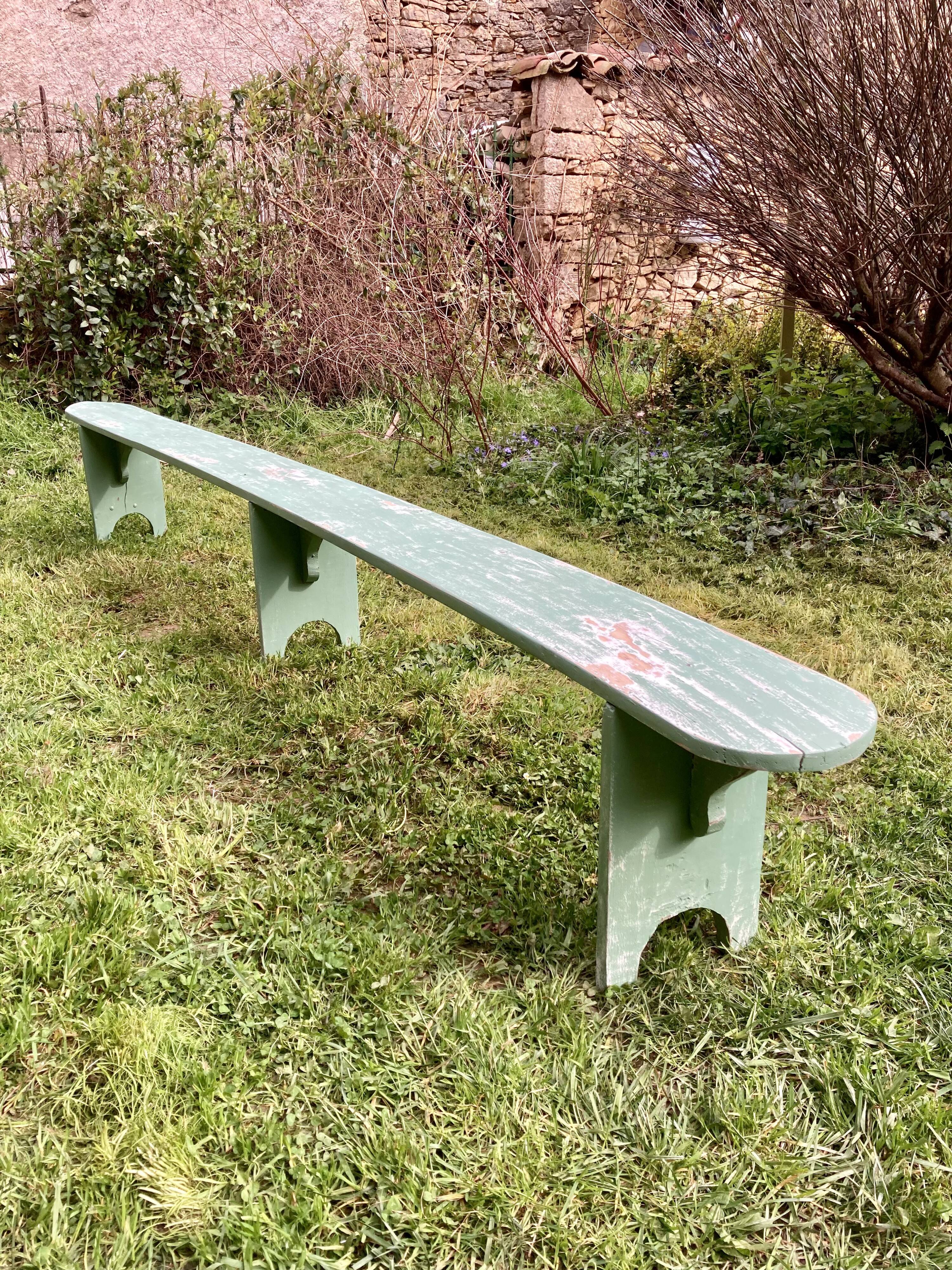 Old curved wooden farm bench