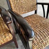 Set of two colonial dark-brown wooden armchairs with natural rattan seating (pair)
