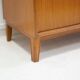 Modern Scandinavian wardrobe in teak with sliding doors and drop-down flap.