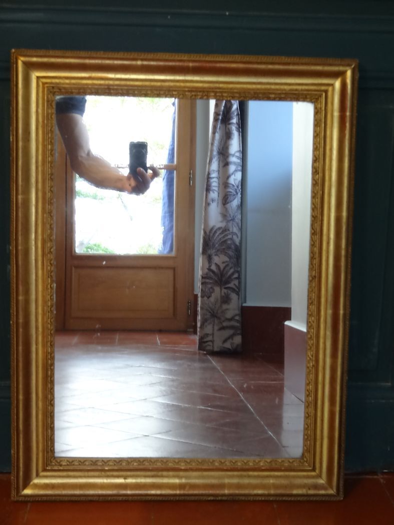 Empire period mirror, early nineteenth in gilded stucco wood H 72 cm