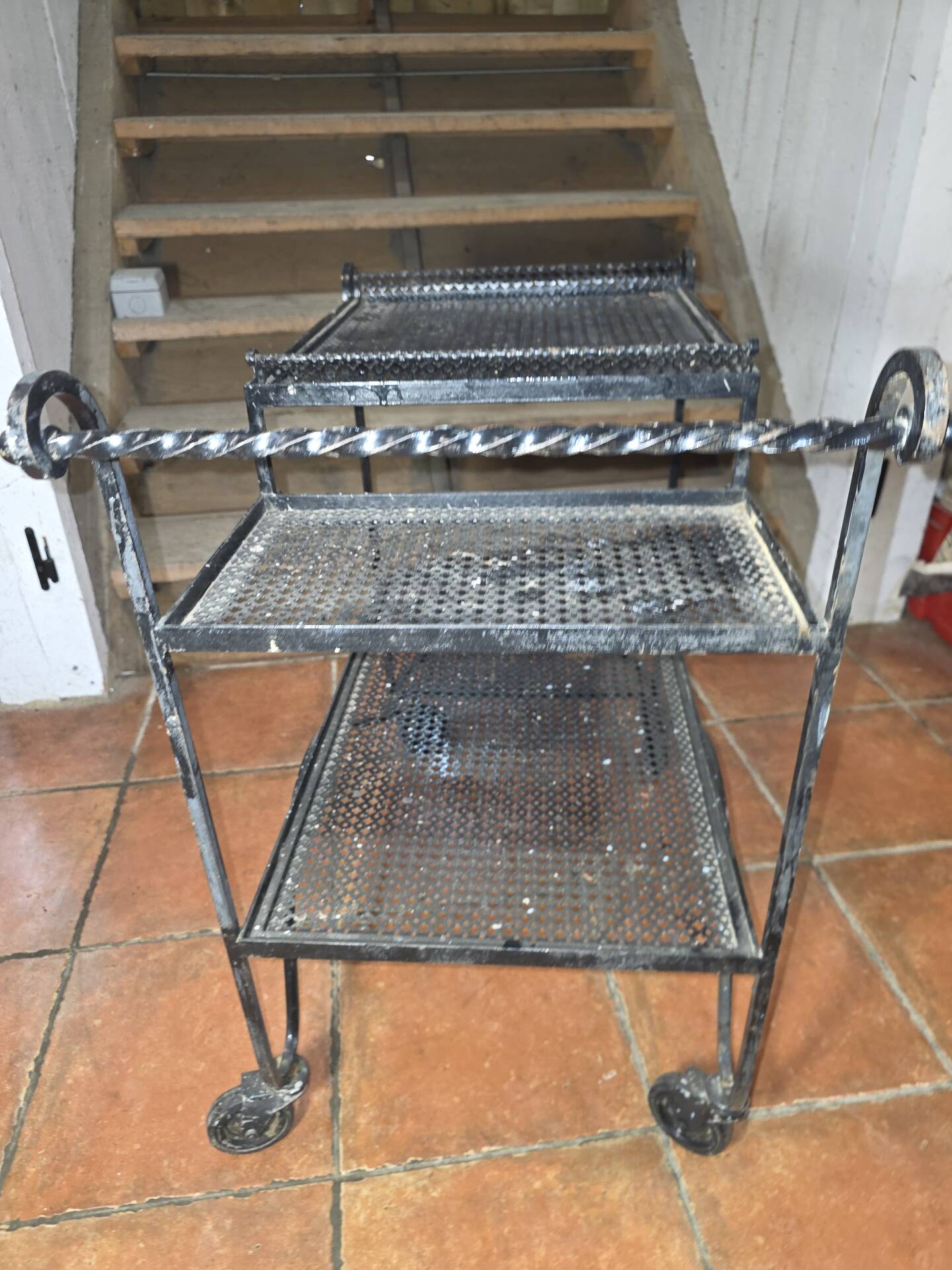 Perforated wrought iron rolling dessert trolley