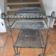 Perforated wrought iron rolling dessert trolley