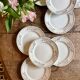 Set of 8 vintage white and gold dessert plates.