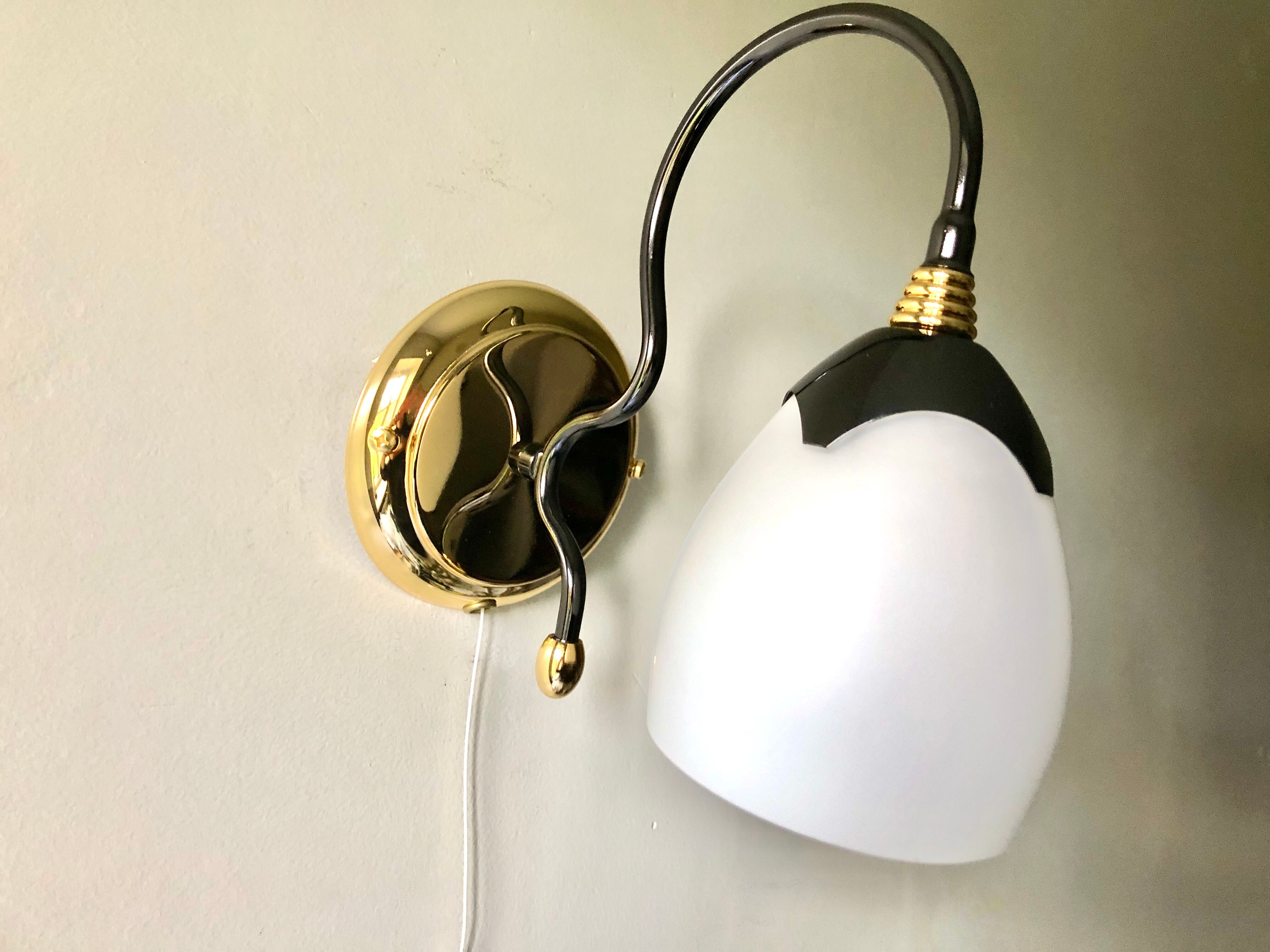 Black and gold wall light with white opaline flower, Italy 1990.