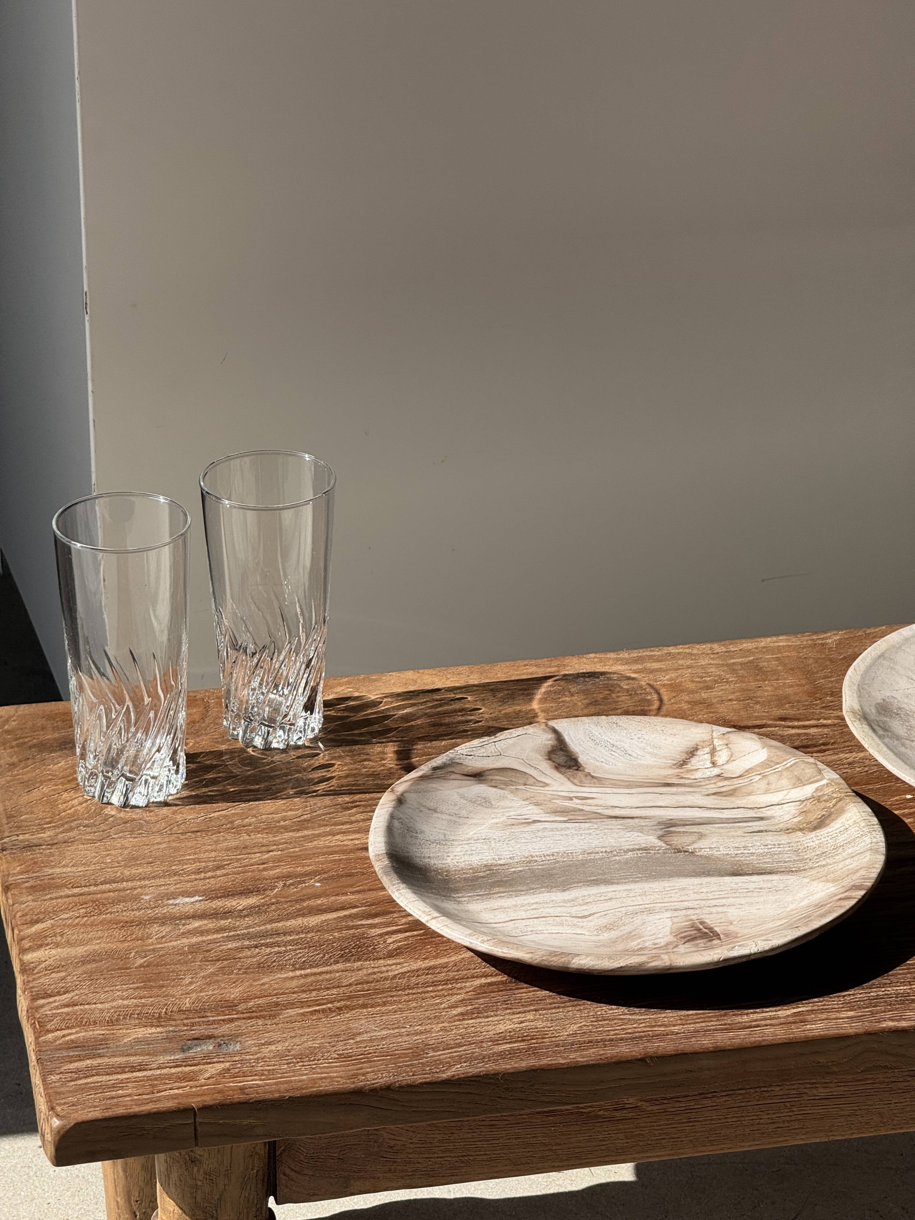 Tray, circular dish or plate made of white striped grey petrified wood.