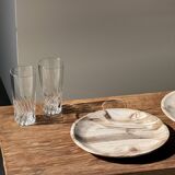 Tray, circular dish or plate made of white striped grey petrified wood.