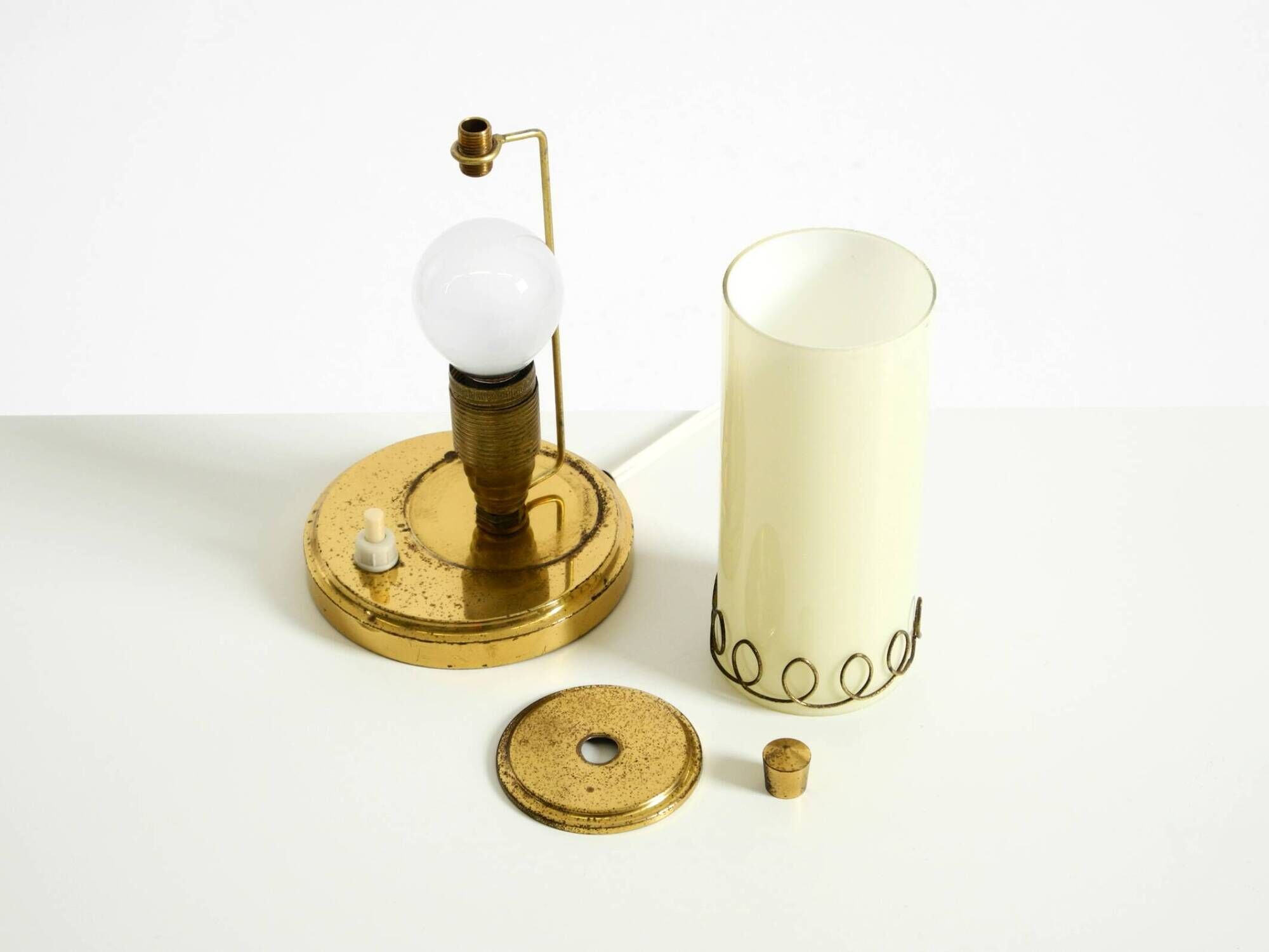 A beautiful, rare 1950s brass table lamp with one opal glass shade adorned