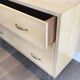 Eggshell lacquered chest of drawers with brushed steel legs. In the style of Knoll.