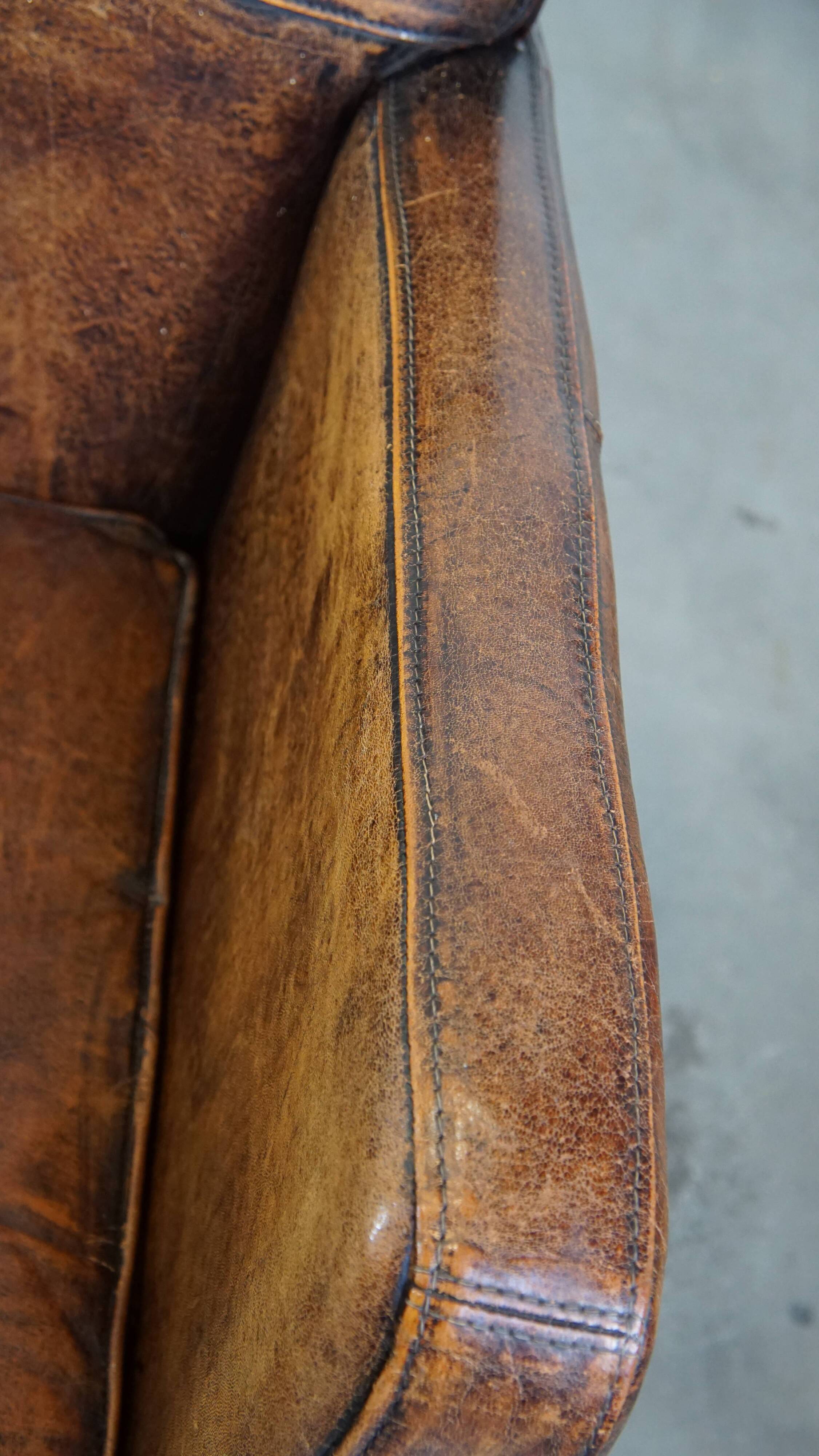 Dark brown design armchair made of sheepskin leather