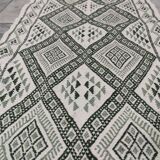 Handwoven white and green rug