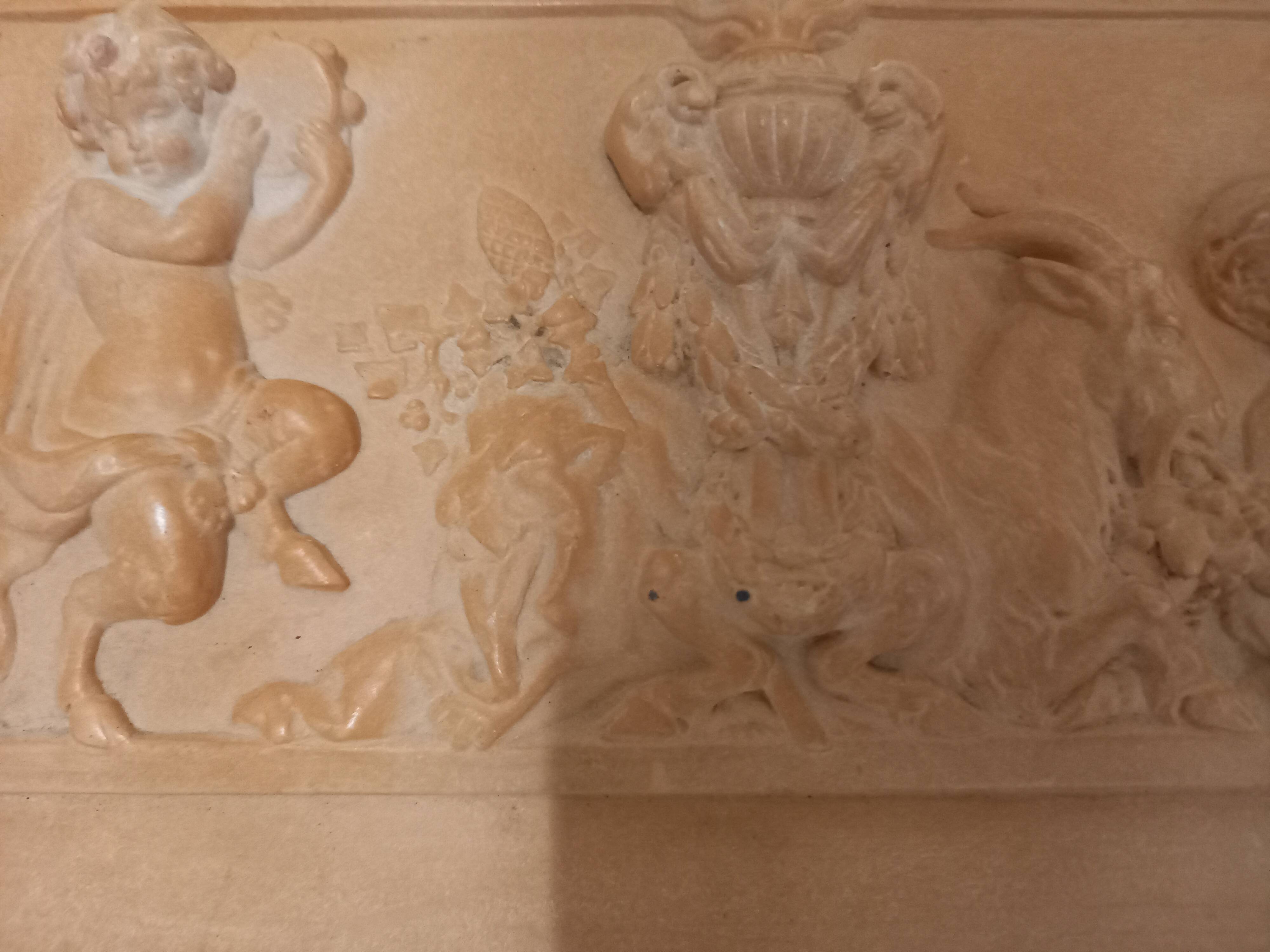 Bas relief, over door, terracotta, children and fauns harvesting grapes