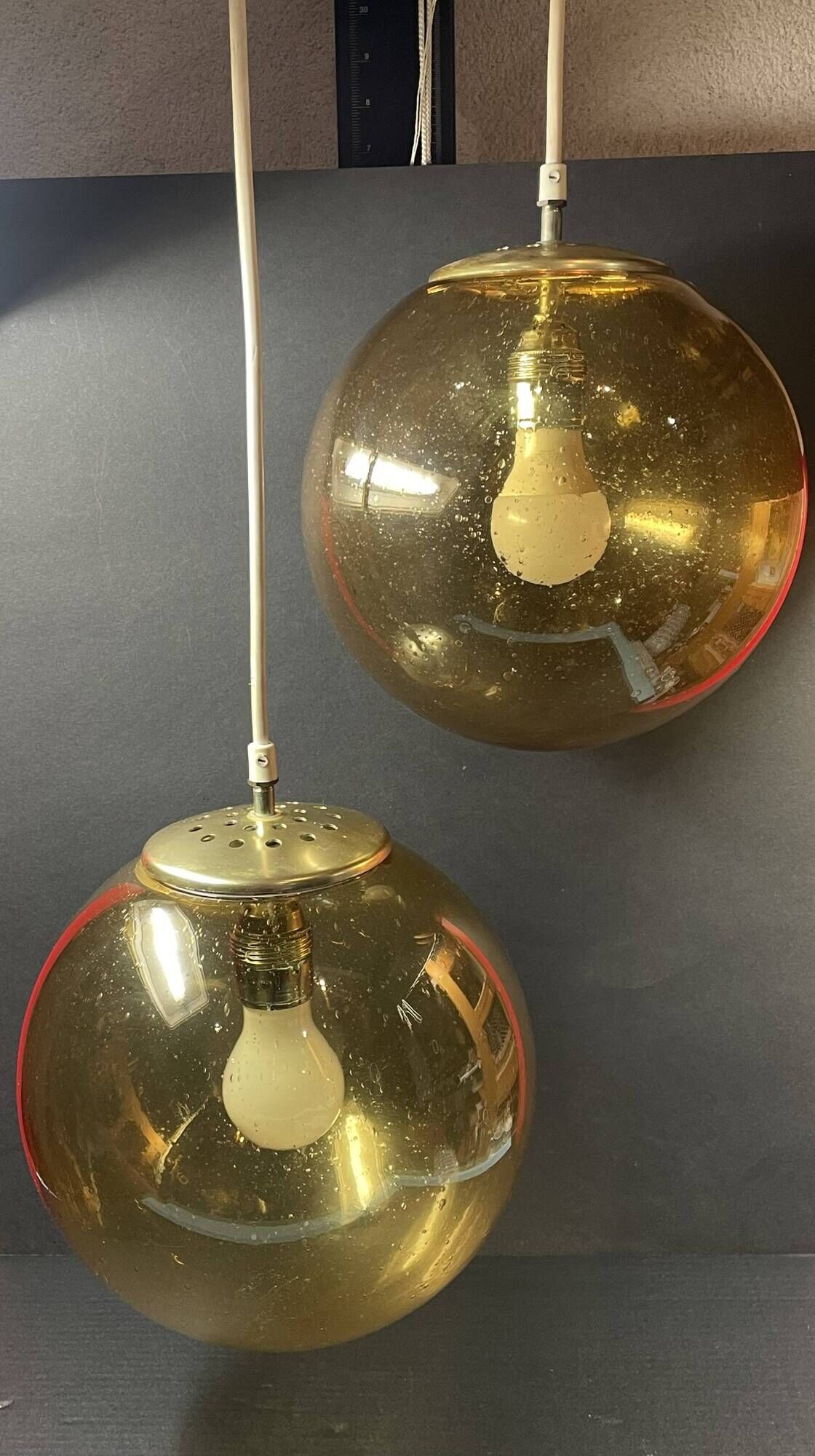 Pair of vintage smoked glass ball pendant lights from Biot glassworks