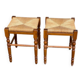 2 square stools made of carved solid wood with rush seats from the 1970s.