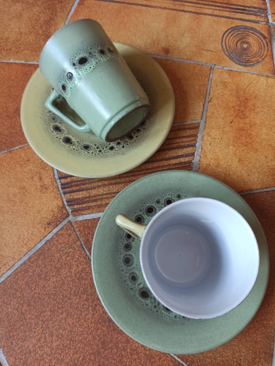 A pair of vintage glazed stoneware cups and saucers.