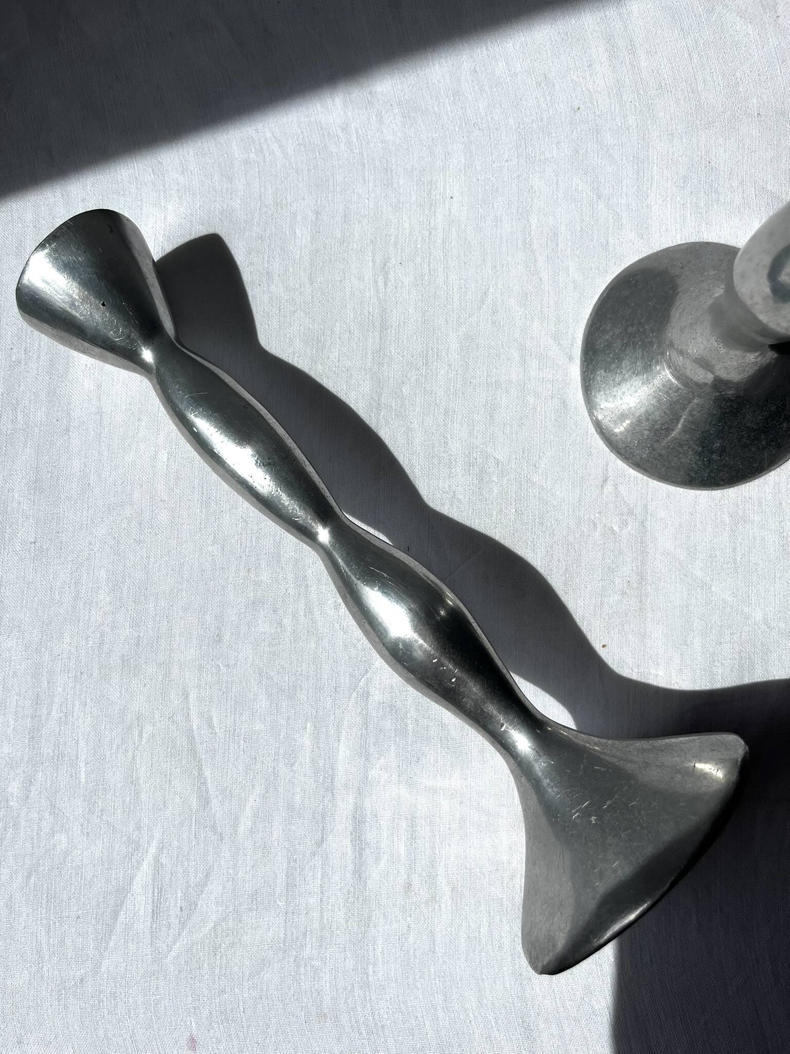 Pair of wavy aluminium candle holders