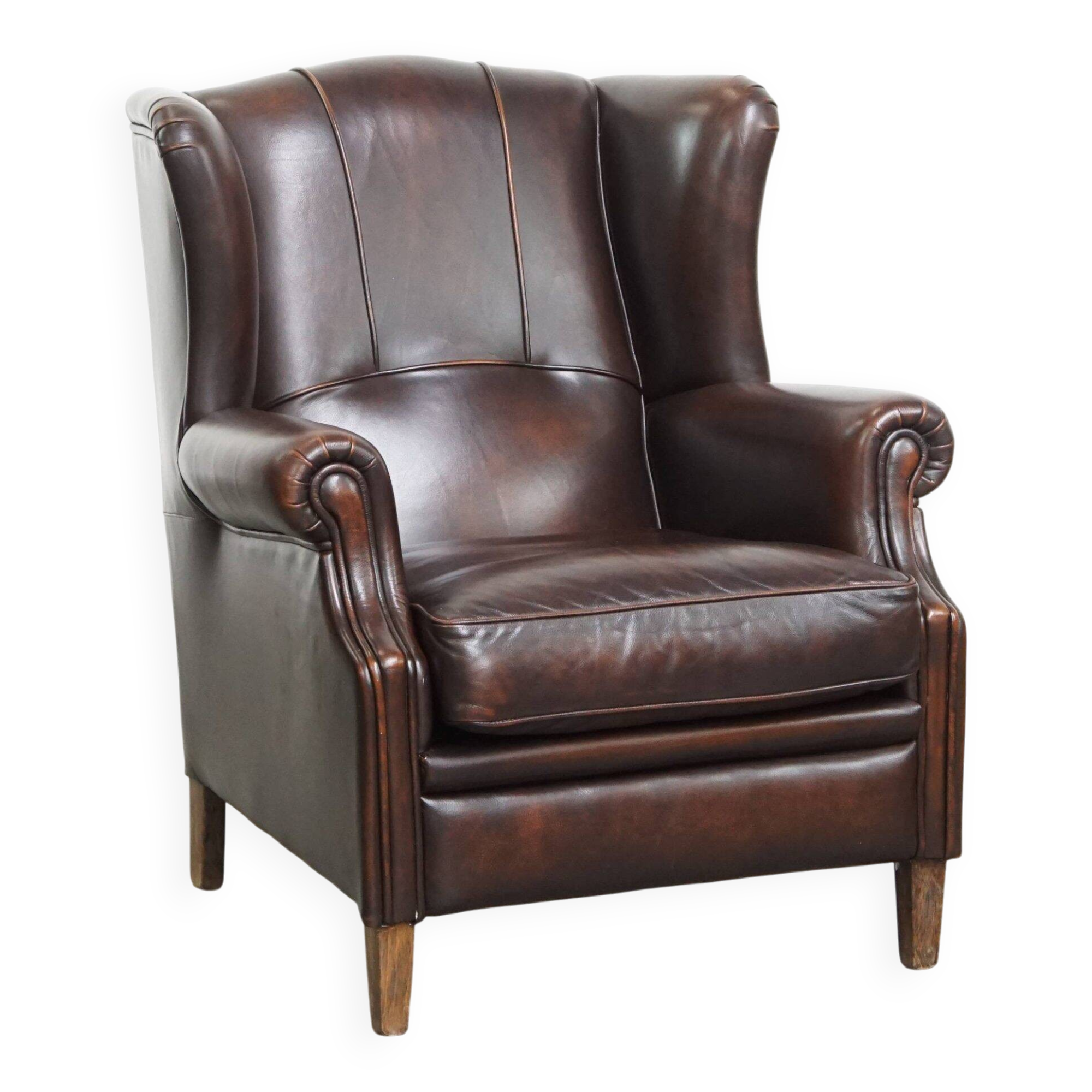Comfortable wingback chair in English style made of cowhide leather