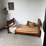 Brutalist style bed with chain and straw