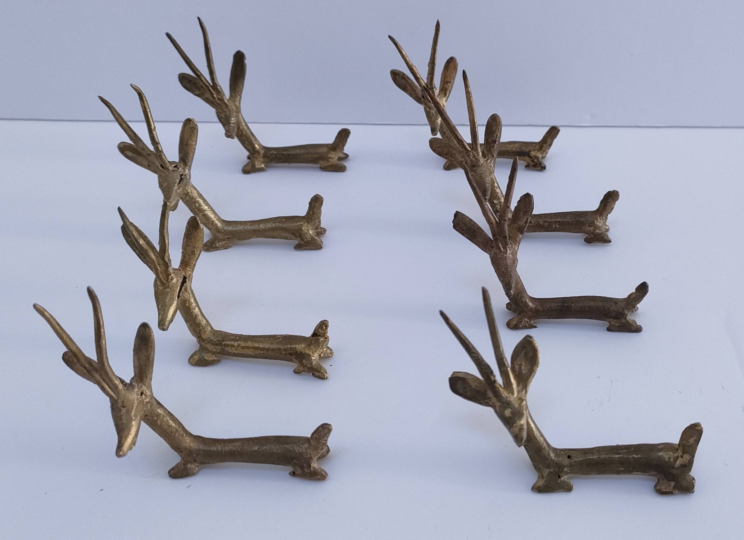 eight vintage brass Gazelle knife rests
