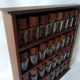 Wooden shelf with 32 vintage Cole & Mason spice jars