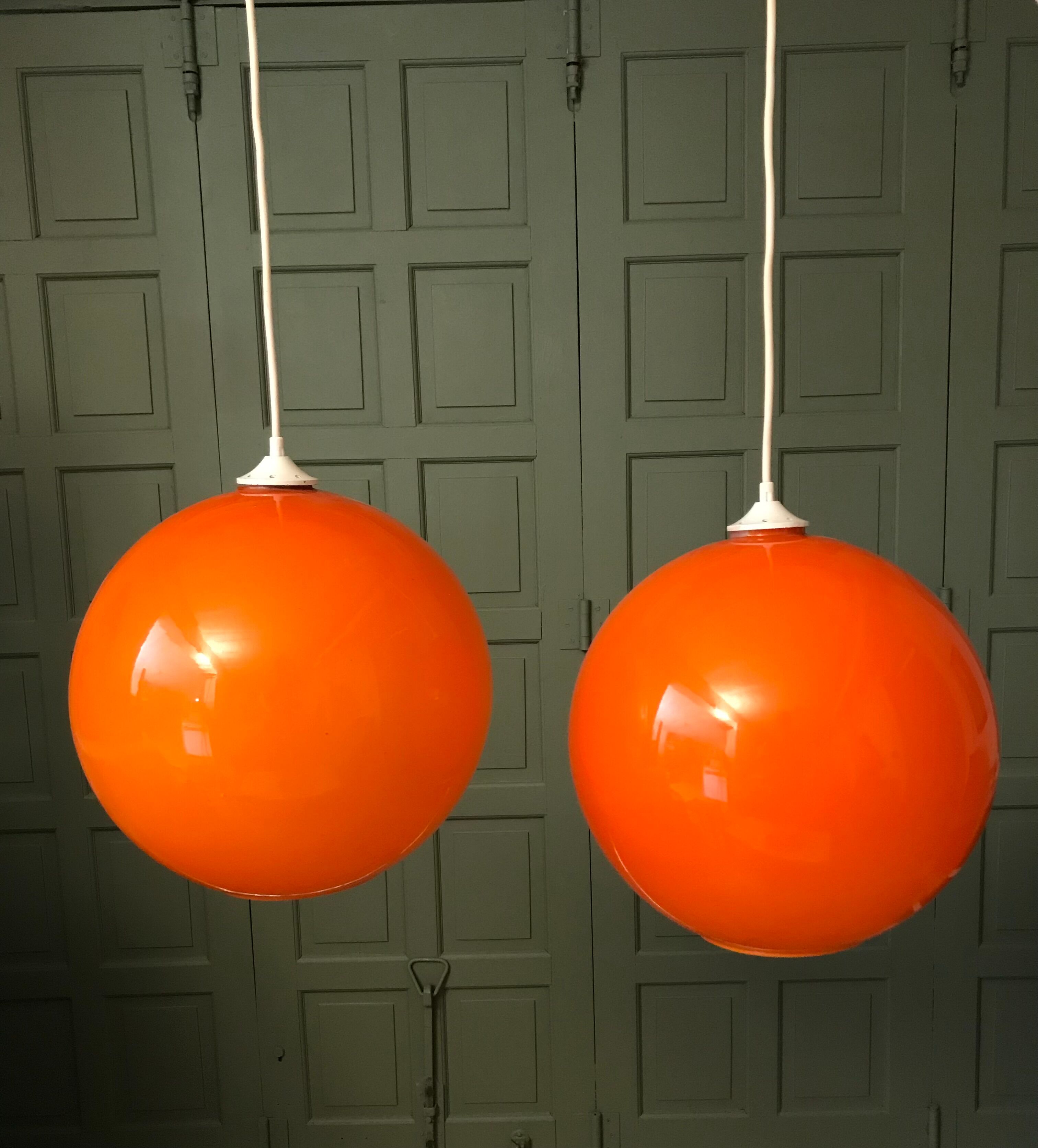 Pair of orange glass ball suspensions, 70s.