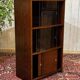 Small English oak library from the 1960s with sliding doors.