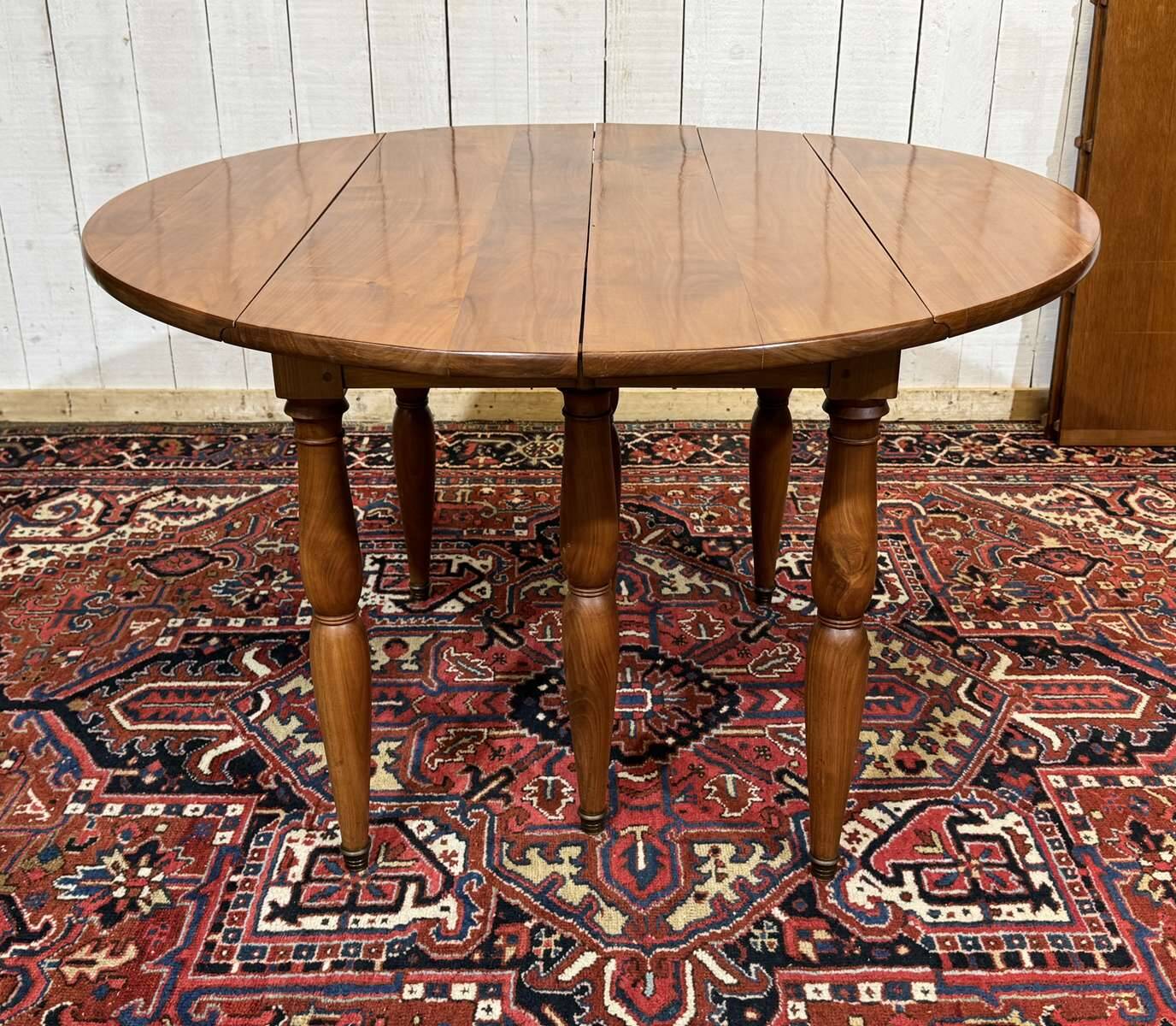 Round cherry wood table, 6 feet, Louis Philippe style with 2 extensions.