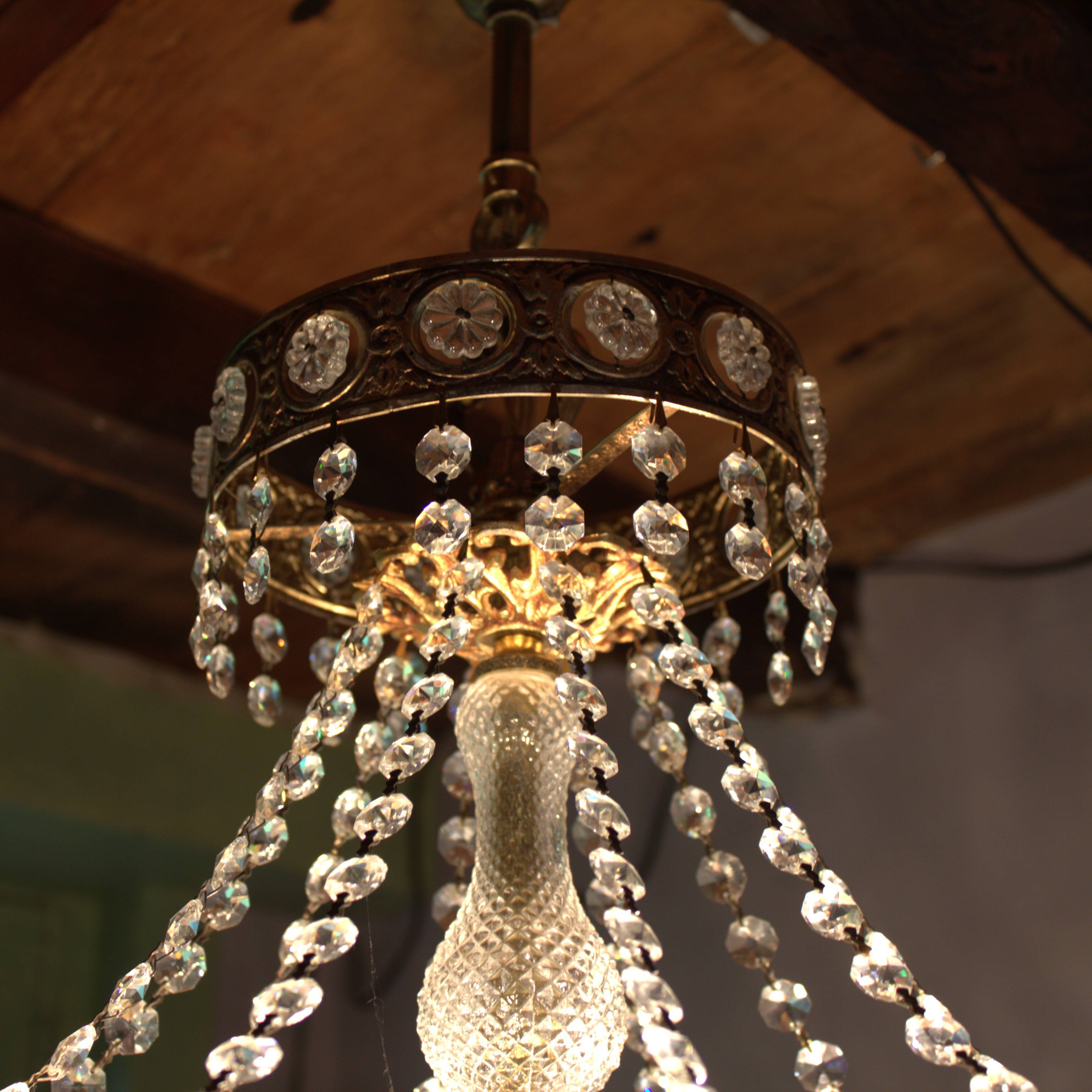 Antique castle style chandelier with tassels and floral details