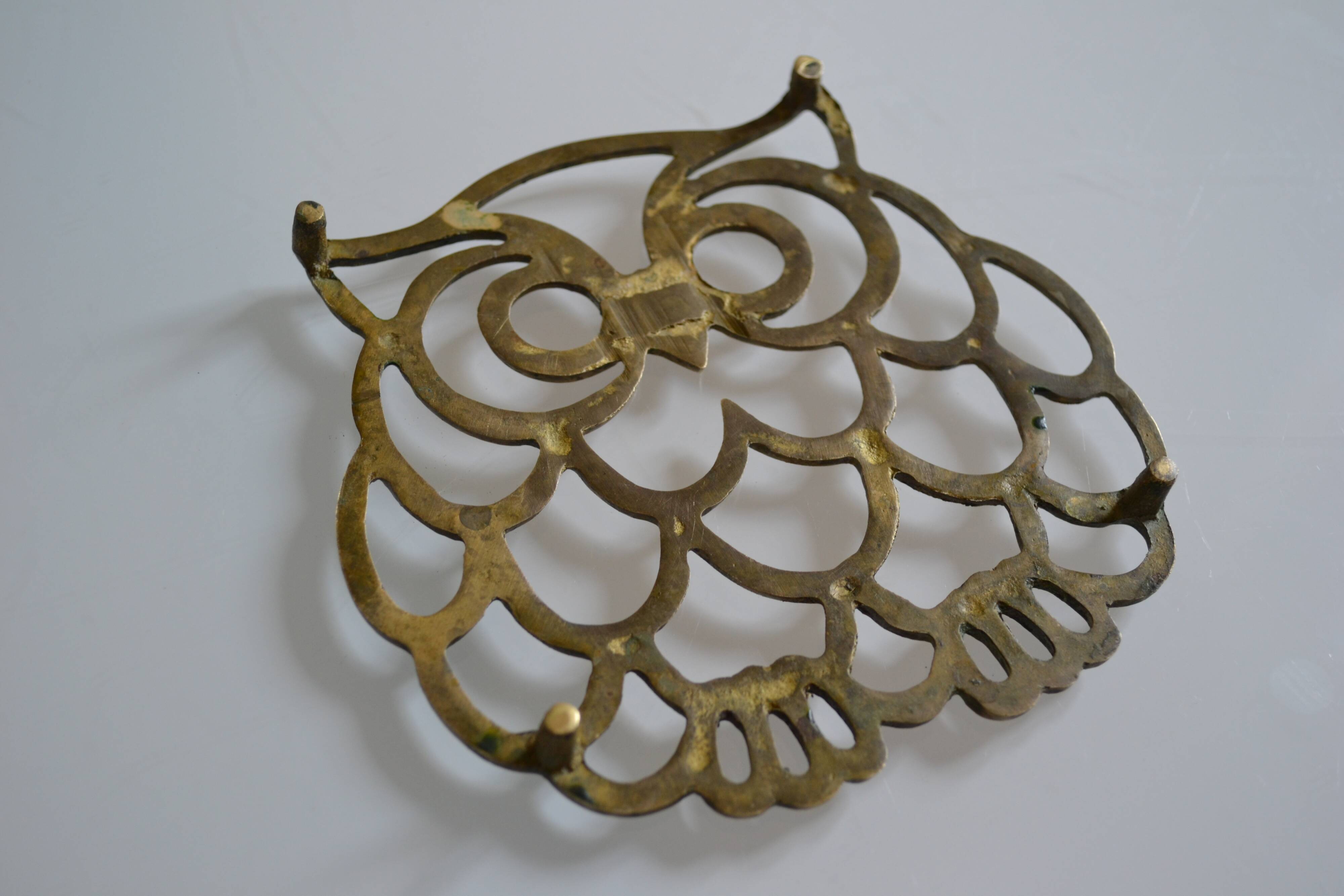 Vintage openwork brass trivet in the shape of an owl or owl