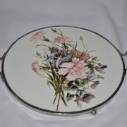 Round white porcelain and metal cake stand, floral decoration, antique style.