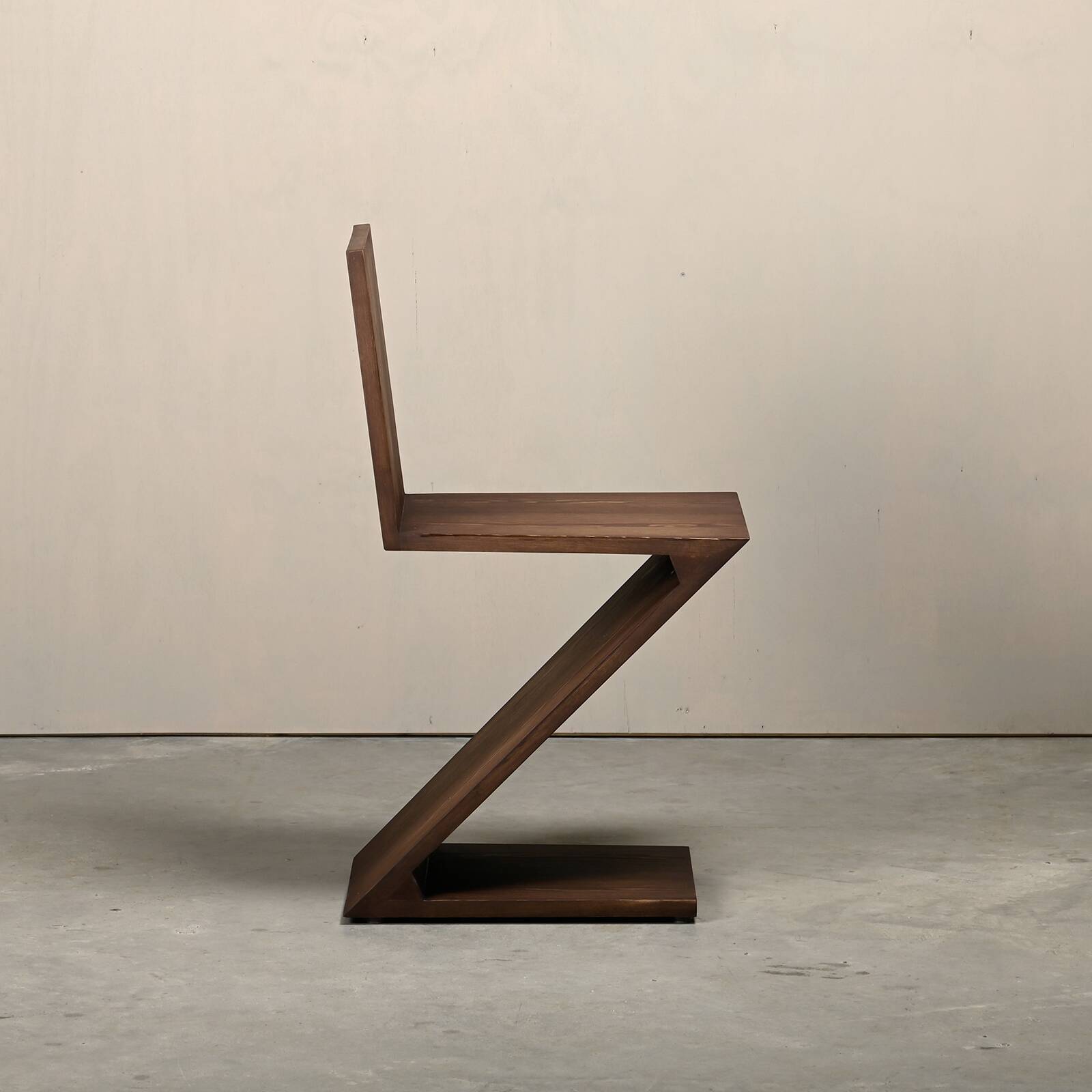 Gerrit Rietveld Zig Zag Chair is dark brown stained wood