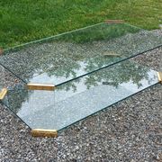 1970s designer coffee table in glass, plexiglass, and gold metal.