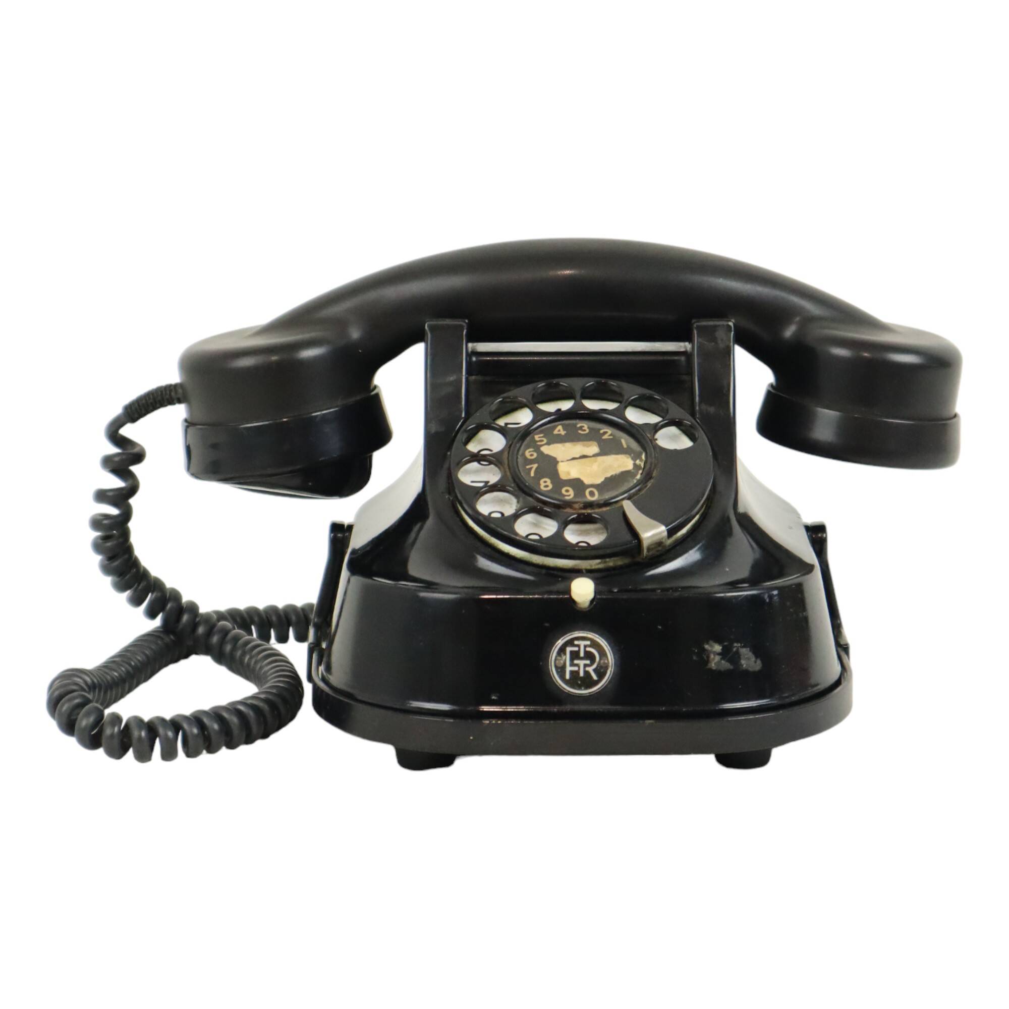 Old black telephone with rotary dial metal Bakelite RTT 56B