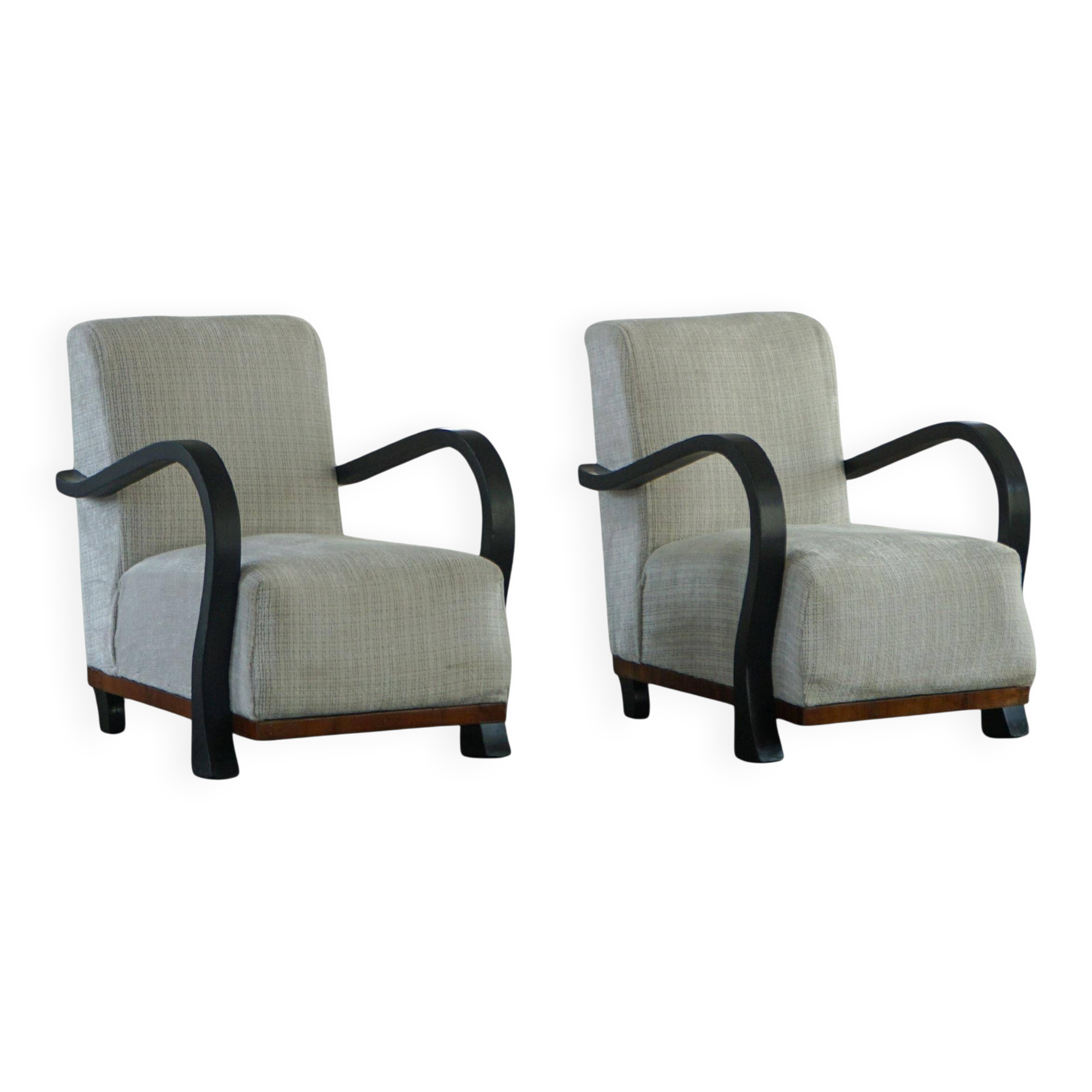 A pair of Swedish Art Deco lounge chairs with curved armrests, 1930s.