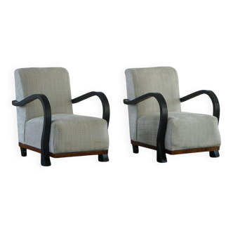 A pair of Swedish Art Deco lounge chairs with curved armrests, 1930s.