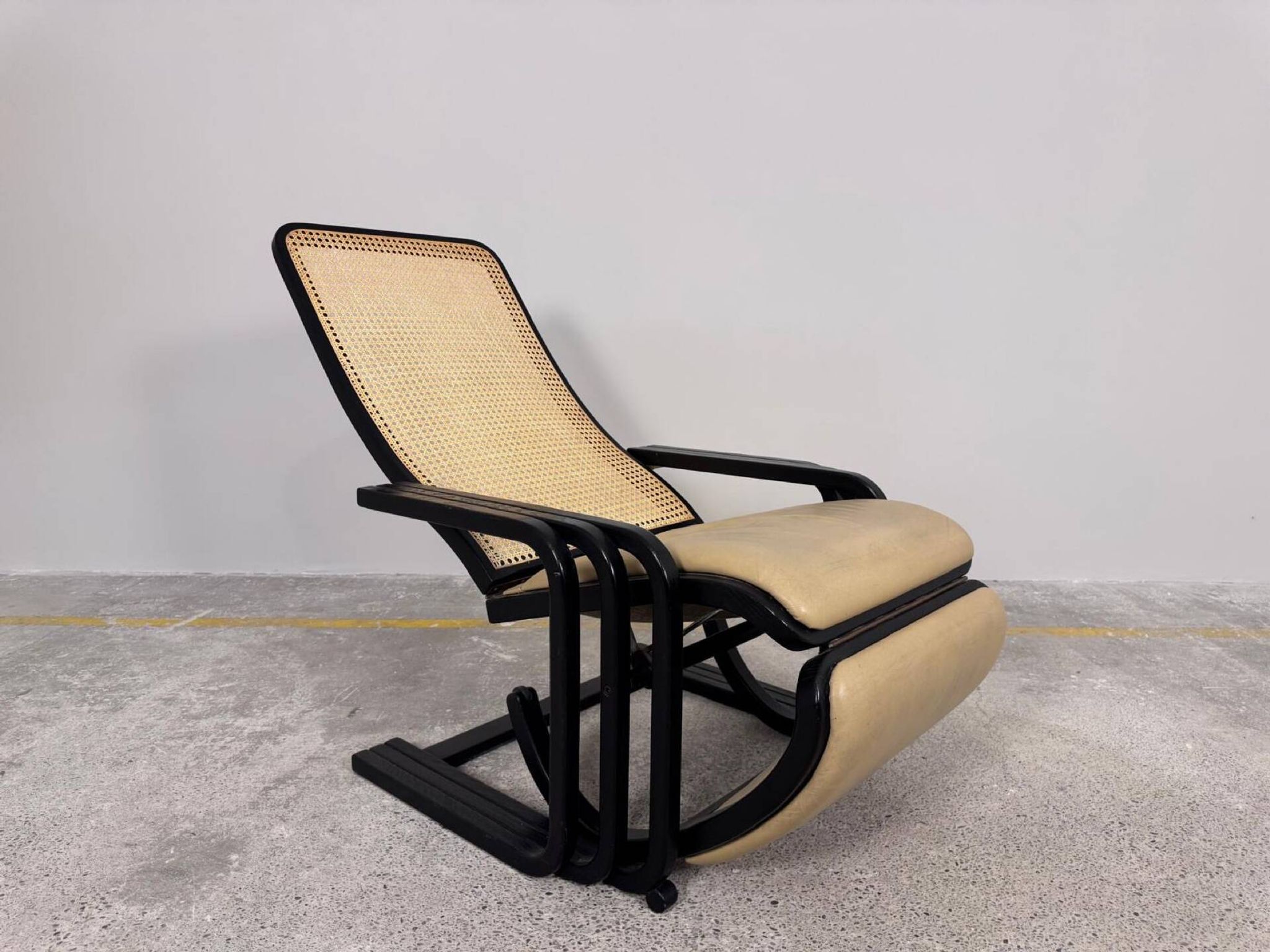 Rocking lounge chair, curved wood, leather, Viennese cane design.