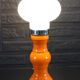 Table lamp or bedside lamp from the 1960s-70s in orange and chrome.