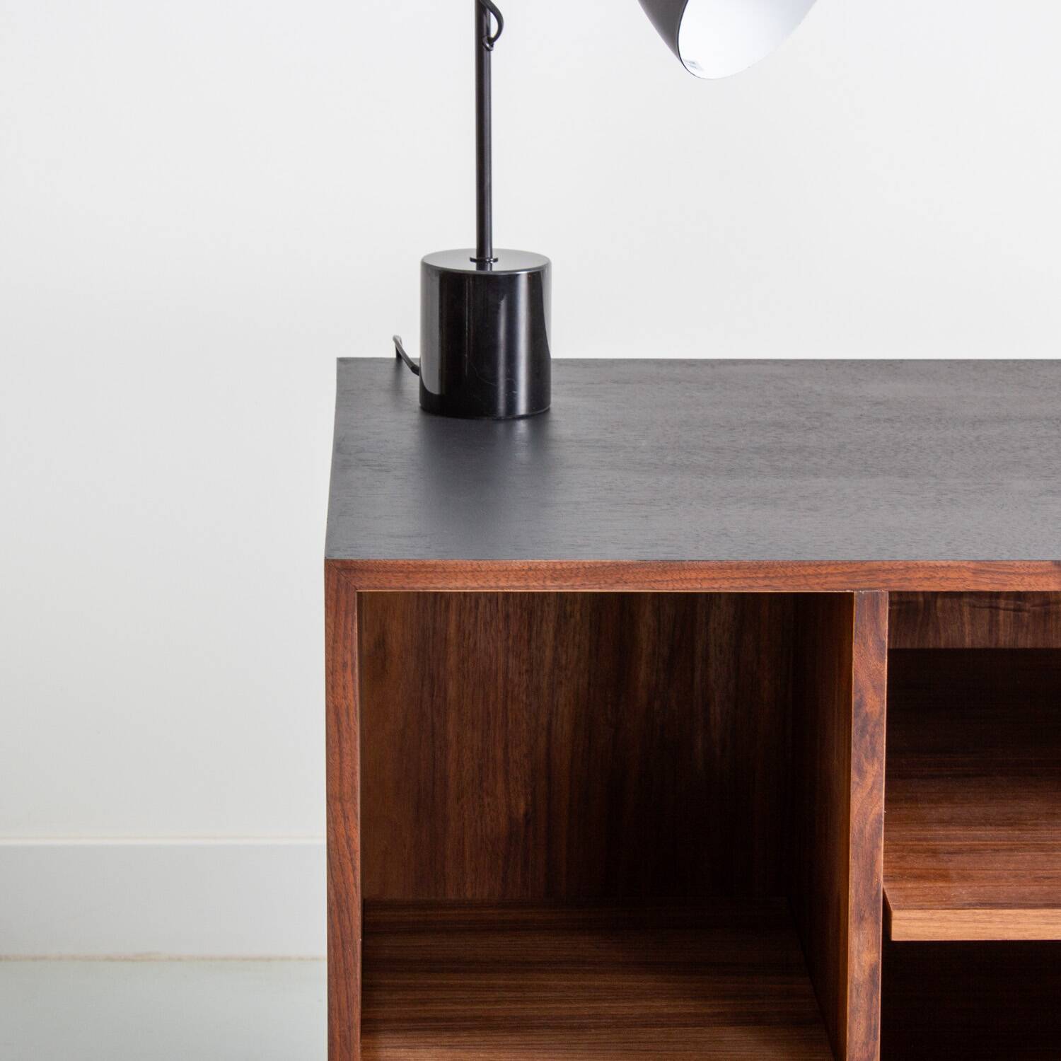Chest of drawers in walnut and black paint, solid walnut base